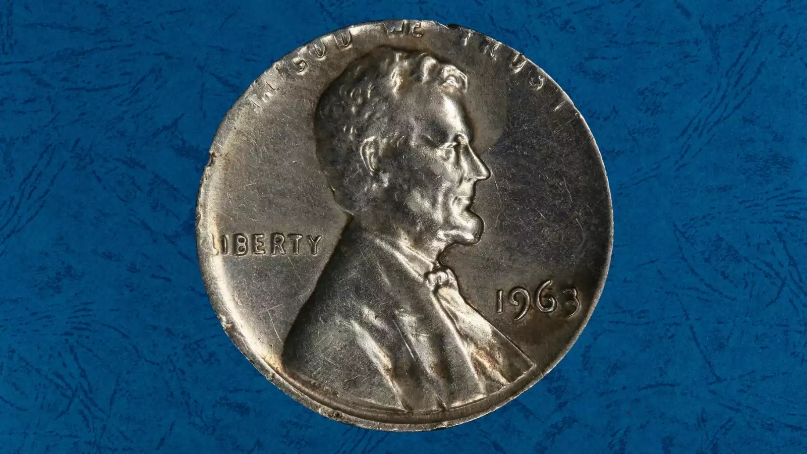 1963 Lincoln cent struck on silver dime planchet showing smaller size and silvery appearance compared to normal copper penny